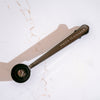Loose tea scoop with Smith Teamaker logo on marble background.
