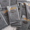 Pile of black wrapped tea sachets.